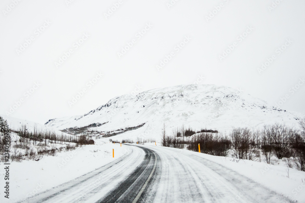 Fototapeta premium Beautiful and dangerous driving road in winter snow Iceland