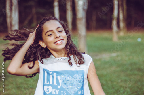 Portrait pretty girl smiling with hand in hair