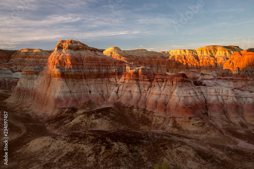 Rainbow Mountains in China. Rainbow City, Wucai Cheng. Colorful layered landforms in a remote desert area of Fuyun County. Uygur Autonomous Region, Xinjiang Province. Early Morning Vibrant Sunrise photo