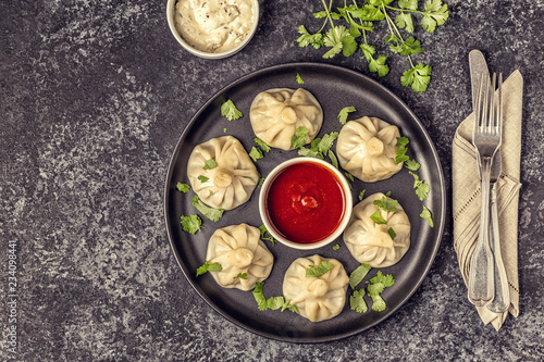 Traditional steamed dumplings Khinkali with Tomato and Tartar sauce