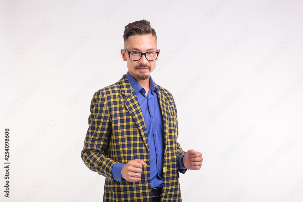 Handsome man in jacket with beard and mustache in glasses standing over white background with copy space Handsome man in jacket with beard and mustache in glasses standing over white background with copy space