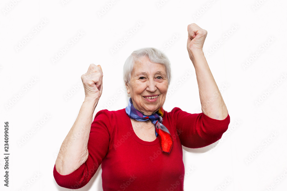 portrait of a mature woman doing a winner gesture. Old smiling woman ...