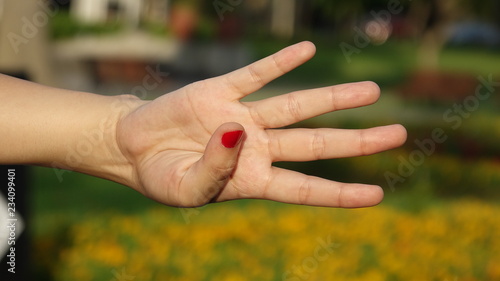 Female Hand Counting Four