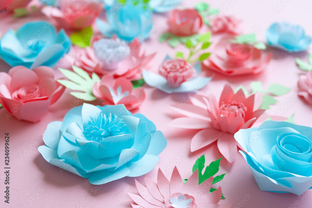 Blue and pink paper flowers on the pink background Blue and pink paper flowers on the pink background