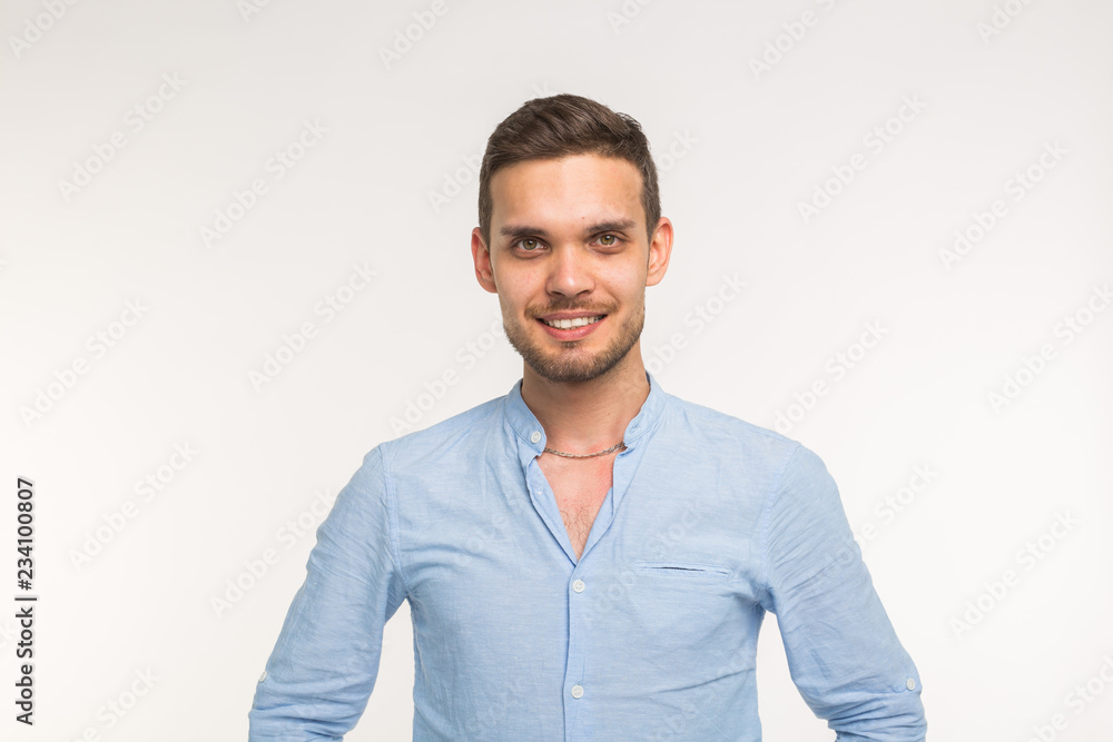 Confident young handsome man smiling on white background Confident young handsome man smiling on white background