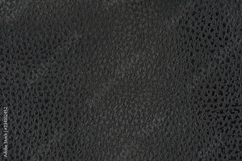 Black natural leather texture macro. Dark material with a pattern, wallpaper background