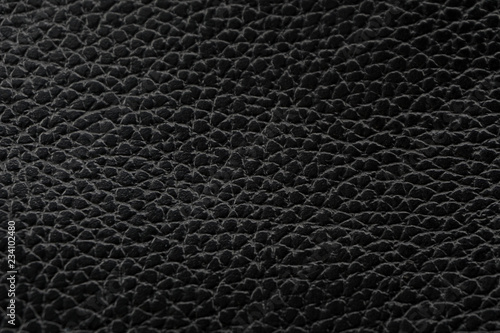 Black natural leather texture macro. Dark material with a pattern, wallpaper background