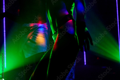 ass young guy gay in sexy underwear on colored lights clubs background