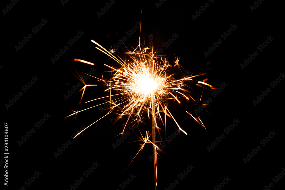 Symbols of the New Year on a dark background. New year party sparkler on black background.