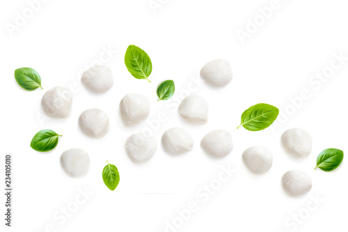 Composition with Mozzarella and  basil leaf isolated  on white background. Traditional Italian Mozzarella cheese balls close up. Top view
