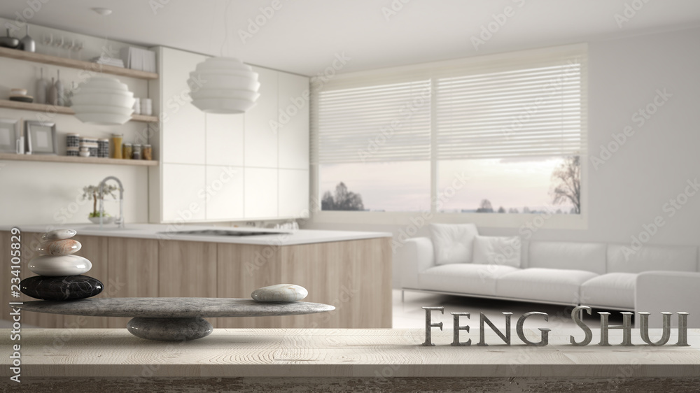 Fototapeta premium Wooden vintage table shelf with stone balance and 3d letters making the word feng shui over blurred modern wooden kitchen with shelves and cabinets, zen concept interior design