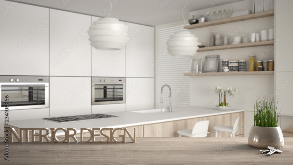 Wooden table, desk or shelf with potted grass plant, house keys and 3D letters making the words interior design, over blurred modern kitchen, project concept copy space background Wooden table, desk or shelf with potted grass plant, house keys and 3D letters making the words interior design, over blurred modern kitchen, project concept copy space background
