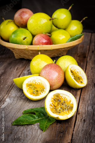 Fresh passion fruit on wooden background. Tropical fruit.