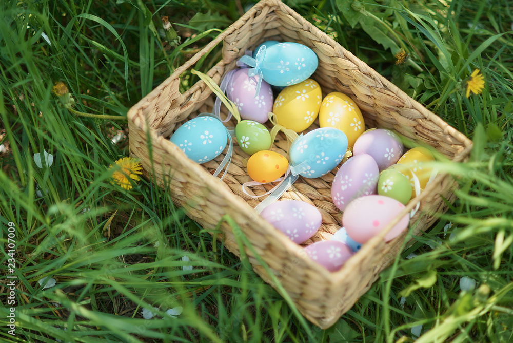 Colorful easter eggs in wooden box on green grass outdoor. Easter background concept Colorful easter eggs in wooden box on green grass outdoor. Easter background concept