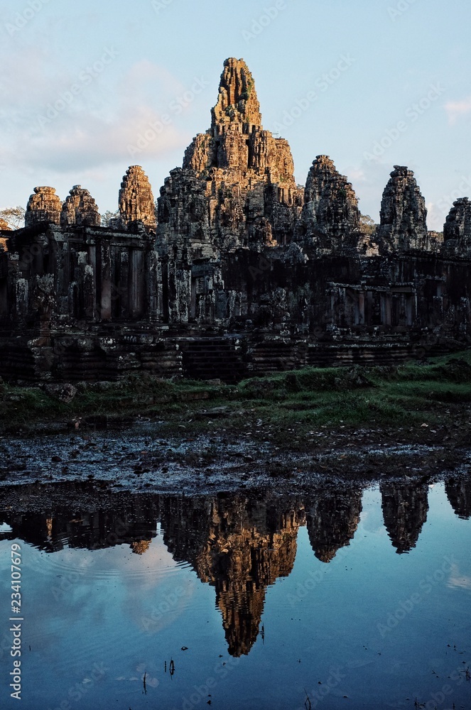 Fototapeta premium one of the most famous temple at sunset with golden light and reflection in the small pond pool of rain water