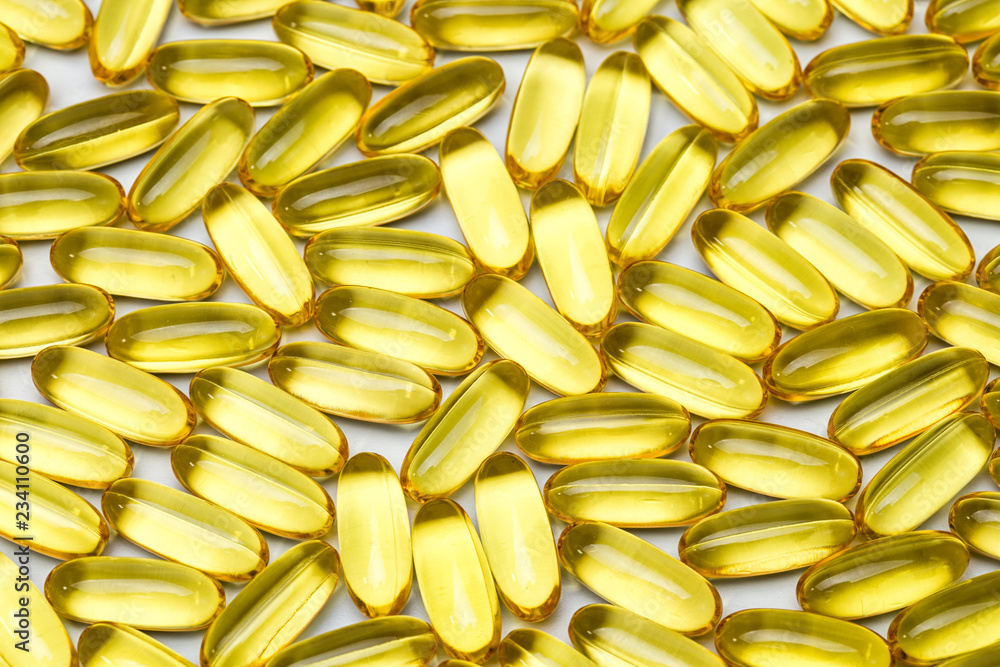 Photo background of yellow healthy vitamin d in capsules Photo background of yellow healthy vitamin d in capsules