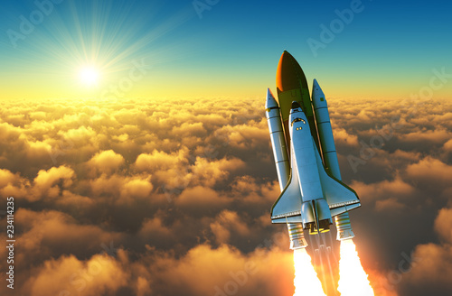 Fototapeta Naklejka Na Ścianę i Meble -  Flight Of The Space Shuttle Above The Clouds In The Rays Of The Rising Sun.