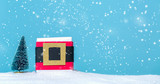 Santa belt gift box in a snow covered landscape