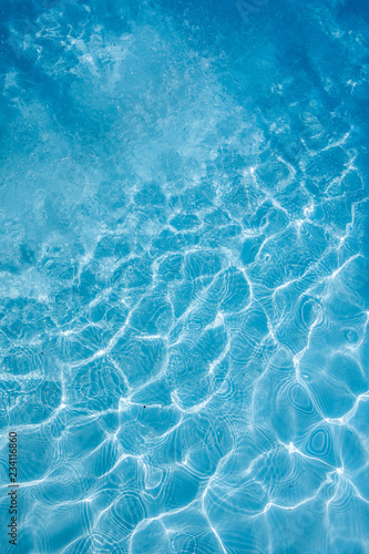 Background of rippled pattern of clean water in a blue swimming pool. © warongdech