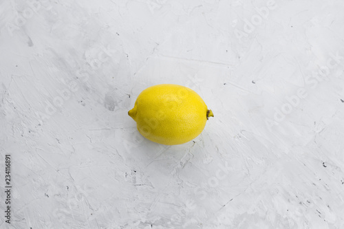 top view juicy lemon on a white concrete shabby  background flat lay minimalism