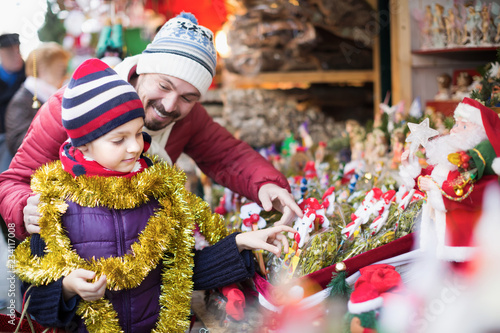 Happy father with small girl buying decorations