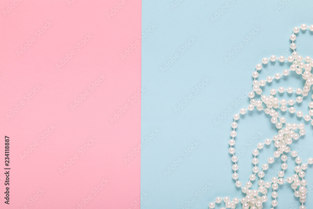 pearl necklace on a blue and pink background