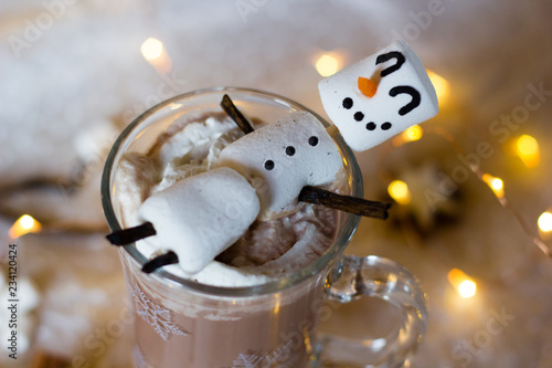 Hot chocolate with marshmallows. Fun food art with snowmen for kids during the winter time. Selective focus