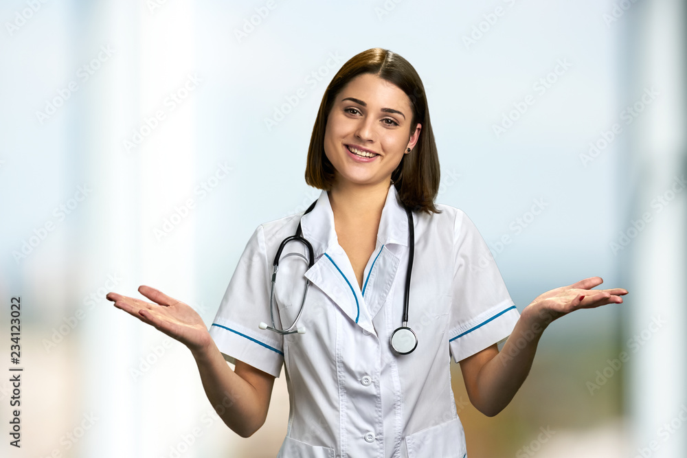Smiling woman doctor with outstretched hands. Portrait of happy doctor with empty hands palm. Smiling woman doctor with outstretched hands. Portrait of happy doctor with empty hands palm.