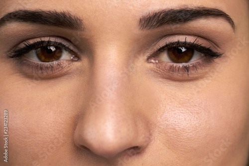 Close up female eyes with natural makeup. Human eyes emotions. Cosmetics and makeup.