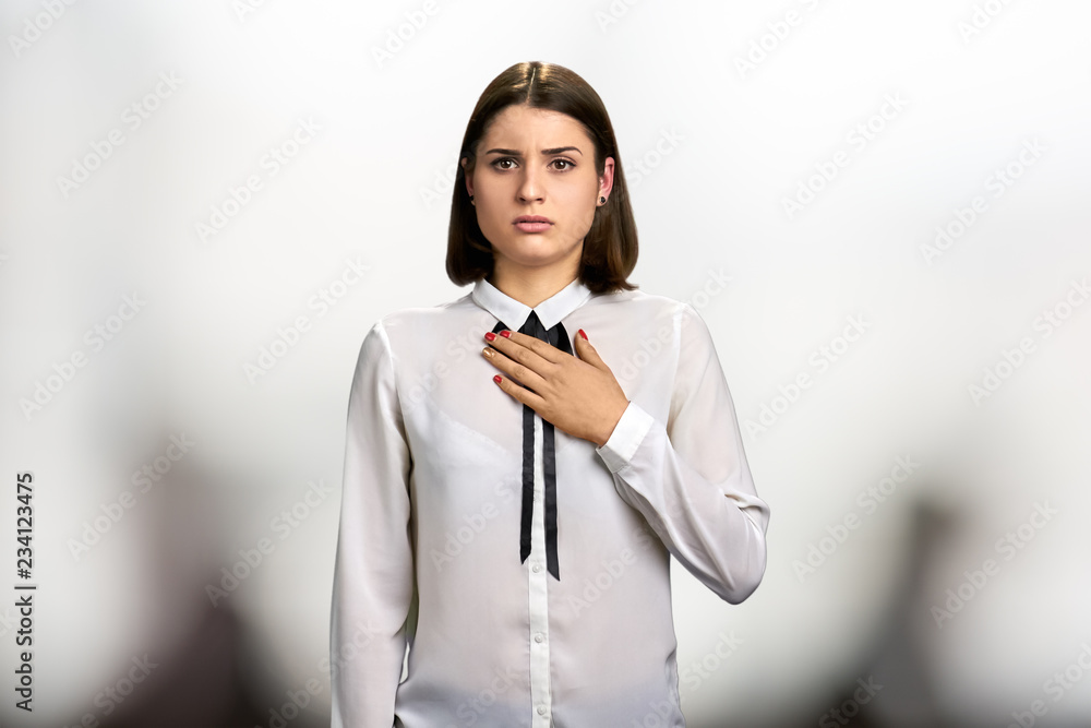 Anxious young brunette with hand on chest. Young pretty woman looking scared. Anxious young brunette with hand on chest. Young pretty woman looking scared.