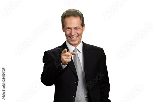 Happy businessman indicating with finger to camera. Portrait of joyful business executive pointing his finger towards camera, isolated on white background.