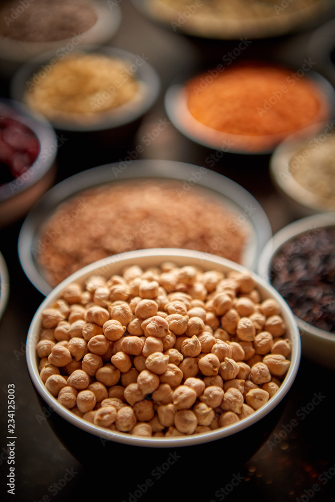 Raw peas seeds in ceramic bowl. Composition of superfoods in background. Placed on dark rusty table. Selective focus. Raw peas seeds in ceramic bowl. Composition of superfoods in background. Placed on dark rusty table. Selective focus.