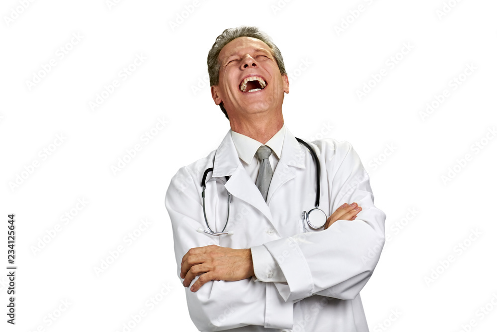 Laughing doctor isolated on white background. Portrait of laughing physician in white coat with arms crossed, copy space. Laughing doctor isolated on white background. Portrait of laughing physician in white coat with arms crossed, copy space.