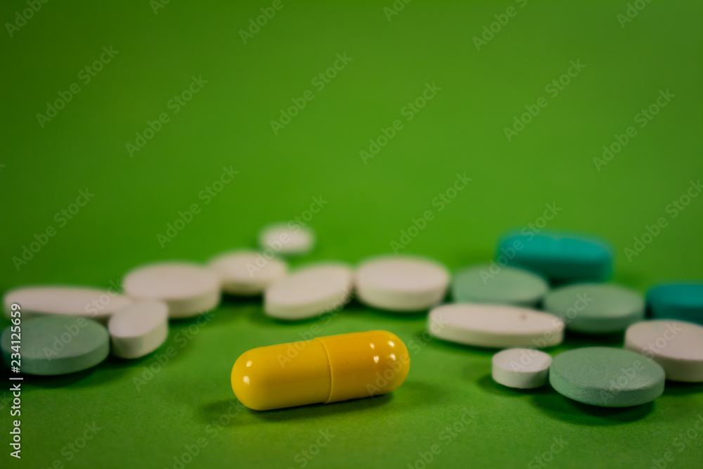 Pills of colors in a neutral background. Medications in the form of tablets. Pills of colors in a neutral background. Medications in the form of tablets.