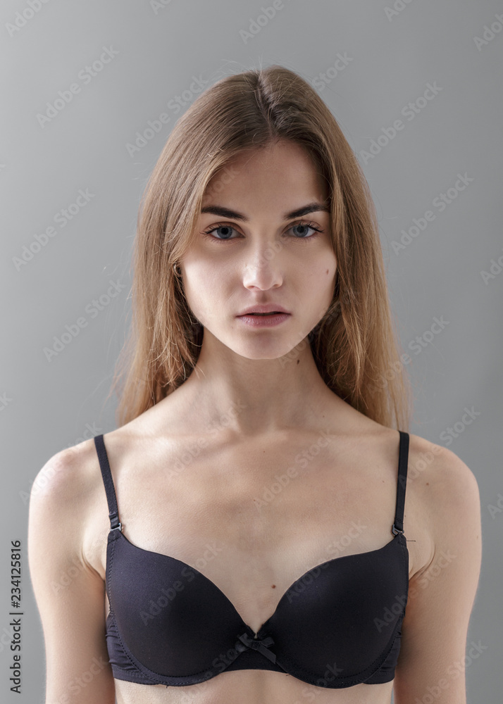 Standard model tests of young pretty woman on a gray background,Test Shots young  models for modeling agency on a gray background with ,young beautiful woman  in underwear. portrait of slim woman Photos