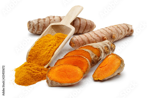 Fresh turmeric with slices and curcuma in spoon isolated on white background