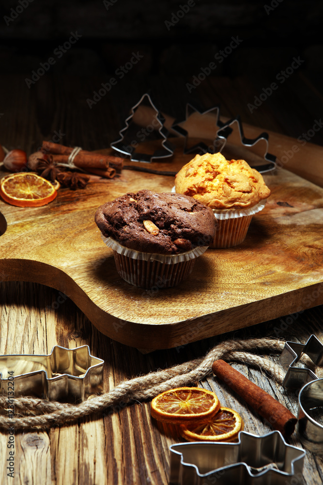 Chocolate muffin and nut muffin, homemade bakery wooden background