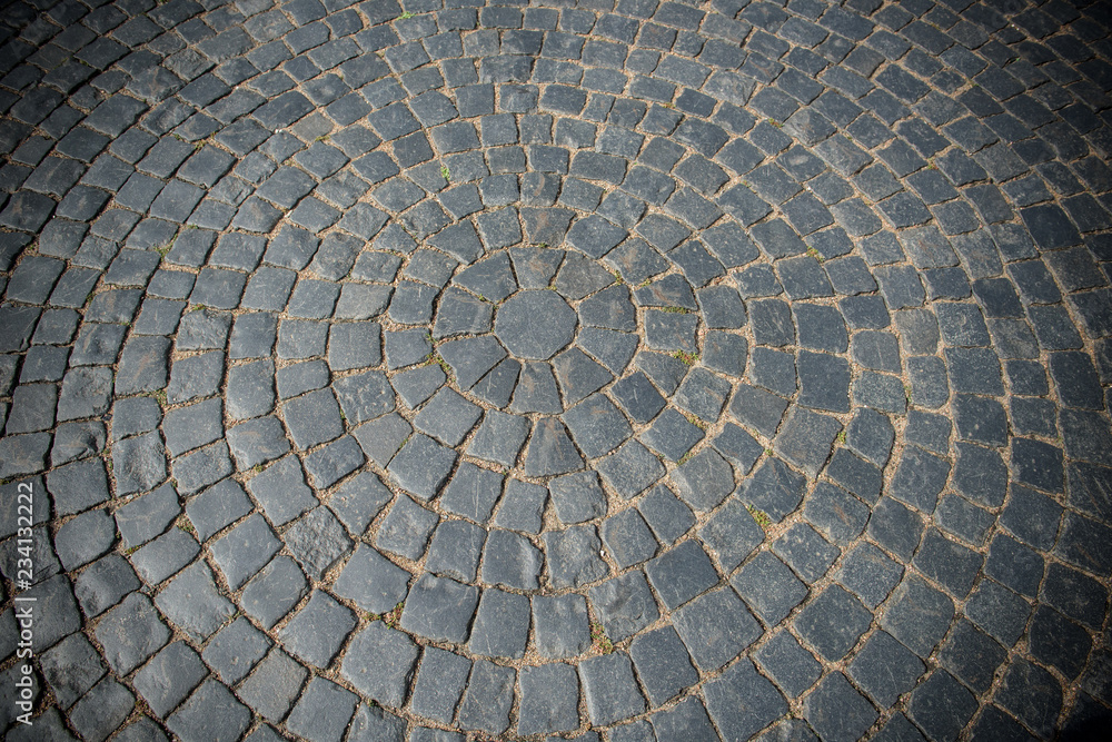 The backdrop of ancient stone blocks. Medieval Paving of squares with stones.
