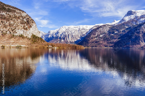 Big calm lake with snow covered mountain on the background © Vladyslav