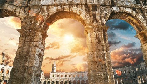 Fotografiet Pula amphitheatre arches with sunset sky background