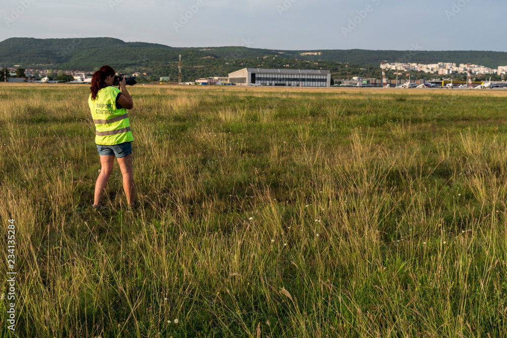 A photographer takes photos of take-off and landing planes.