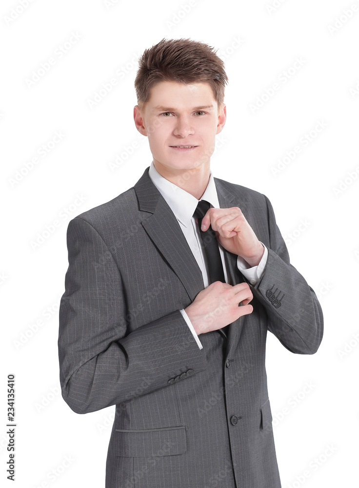 young businessman adjusting his tie.isolated on a white young businessman adjusting his tie.isolated on a white