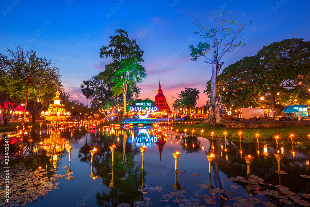 Beautiful scene of The light color Sukhothai Co Lamplighter Loy Kratong Festival at The Sukhothai Historical Park covers the ruins of Sukhothai, in what is now Northern Thailand.