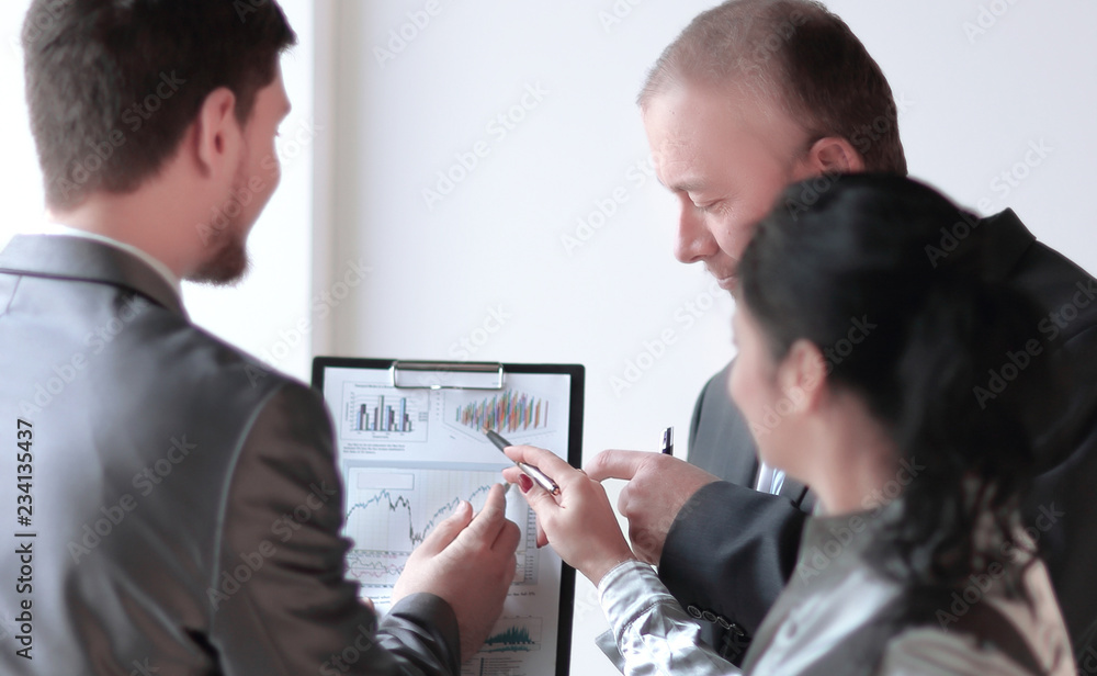close up. colleagues discussing a financial chart. close up. colleagues discussing a financial chart.