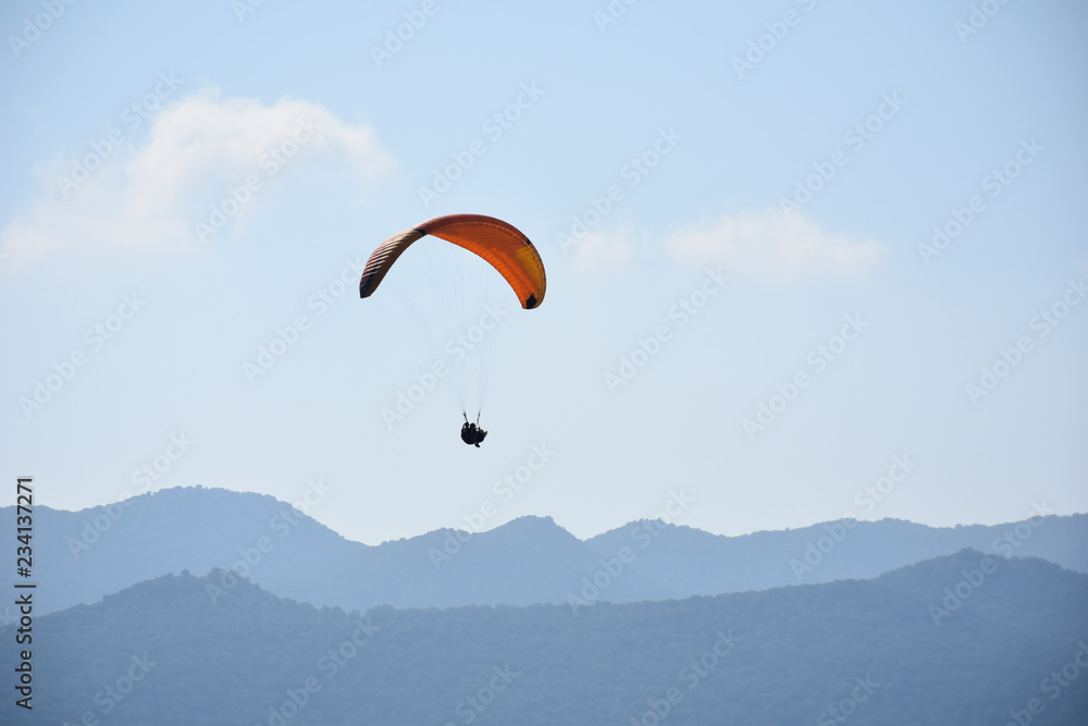 Paraglider on a clear day for background usage. Spaces for type. Paraglider on a clear day for background usage. Spaces for type.