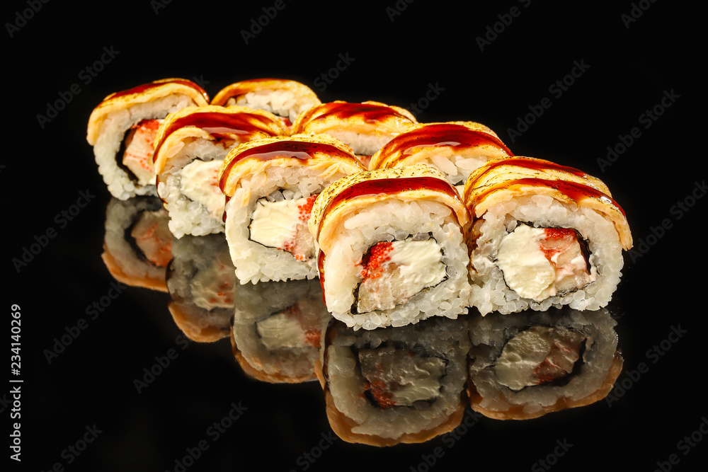Traditional sushi roll with smoked eel, avocado and salmon on dark background. Japanese food Traditional sushi roll with smoked eel, avocado and salmon on dark background. Japanese food