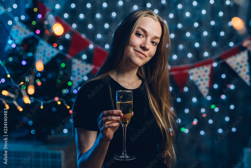 Young woman with a glass of champagne. Celebrating new year, christmas Young woman with a glass of champagne. Celebrating new year, christmas