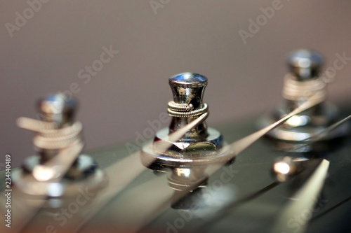 guitar with wooden brown neck and strings, close up blurry background, texture, abstract