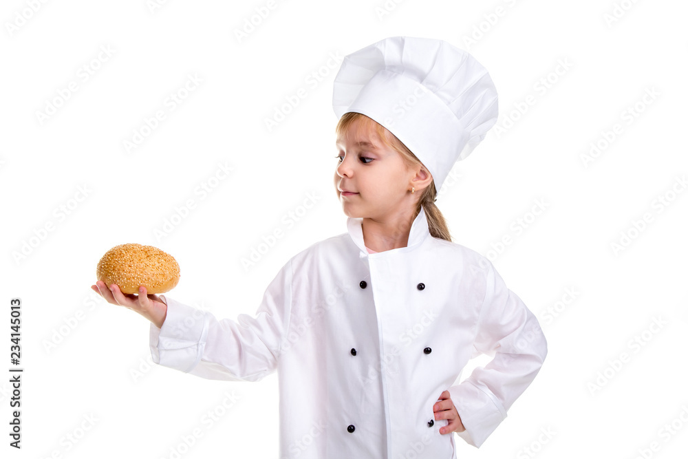 Clever chef girl in a cap cook uniform, holding and admiring the bread with sesame. Looking at the camera Clever chef girl in a cap cook uniform, holding and admiring the bread with sesame. Looking at the camera