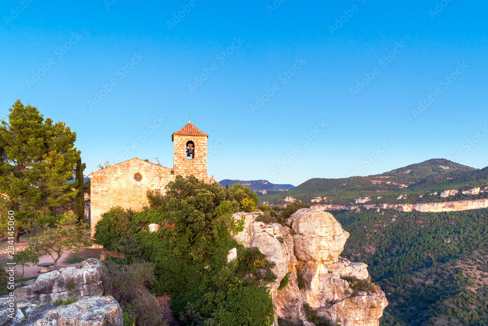 View of the Romanesque church of Santa Maria de Siurana, Tarragona, Catalunya, Spain. Copy space for text. View of the Romanesque church of Santa Maria de Siurana, Tarragona, Catalunya, Spain. Copy space for text.